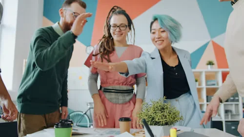 Team members celebrating a shared success with a high five