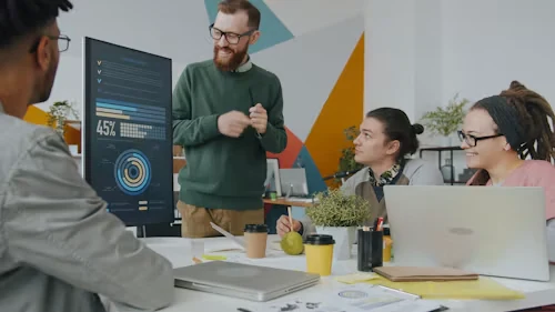 A facilitator presenting a data dashboard to a team