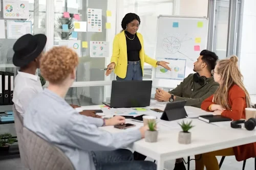 A facilitator leading a planning session at a whiteboard