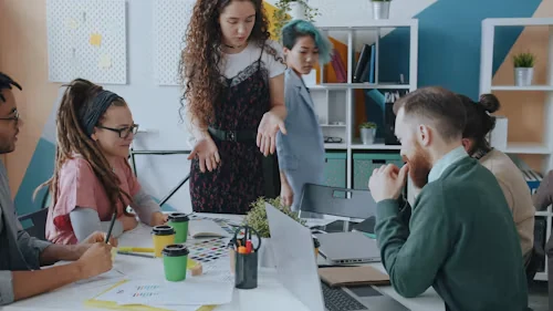 Colleagues collaborating around a table in a bright office